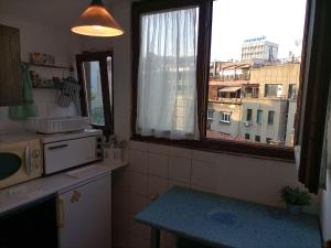 a kitchen with a window with a view of a city at Apartman Lara in Belgrade