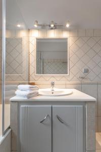 a bathroom with a white sink and a mirror at Villa argo in Glinádhon +92 photos