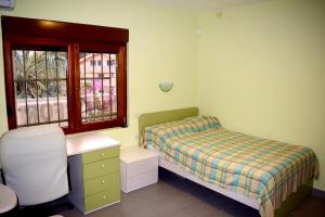 a bedroom with a bed and a desk and a window at Family Villa in Petrovac na Moru