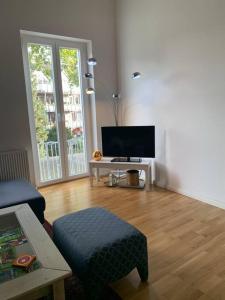 een woonkamer met een bank en een tv bij Mitten im Ruhrgebiet, Willkommen, good wlan , Netflix, Parking Free, 100m2 flat in Oberhausen
