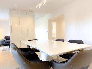 a meeting room with a white table and chairs at G Apartment in Podstrana