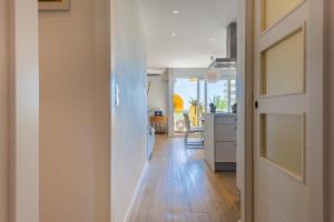 a hallway of a kitchen with a door open at Salamar Saler Golf in El Saler