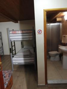 a room with a bunk bed and a bathroom with a toilet at Ali Baba's House in Selçuk