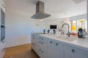 a white kitchen with a sink and a stove at Salamar Saler Golf in El Saler