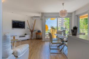 a living room with white furniture and a dining room at Salamar Saler Golf in El Saler