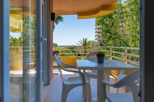 a table and chairs on a balcony with a view at Salamar Saler Golf in El Saler