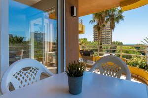 a white table and chairs on a balcony at Salamar Saler Golf in El Saler