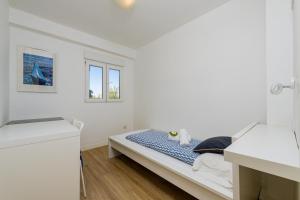 a white room with a bed and two windows at Salamar Saler Golf in El Saler
