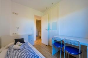 a bedroom with a bed and a blue table and chairs at Salamar Saler Golf in El Saler