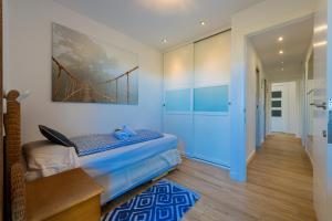 a bedroom with a bed and a bridge painting on the wall at Salamar Saler Golf in El Saler