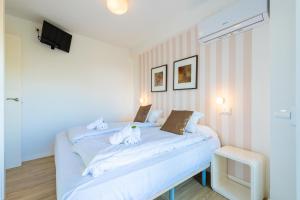 a bedroom with a bed with two stuffed animals on it at Salamar Saler Golf in El Saler