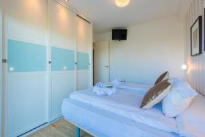 a bedroom with a bed with a shark pillow on it at Salamar Saler Golf in El Saler