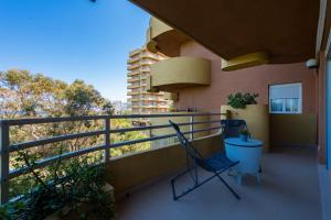 a balcony of a building with two chairs on it at Salamar Saler Golf in El Saler