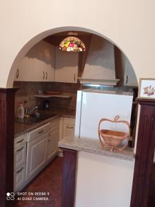 a kitchen with a sink and a white refrigerator at KotorHostelito in Kotor