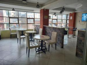 a room with chairs, tables, and tables in it at KIMA HILLS HOTEL in Nairobi