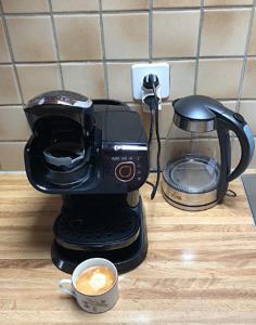 a coffee maker on a counter with a cup of coffee at Charmant Petit Chalet 3 étoiles en Gruyère in Crésuz