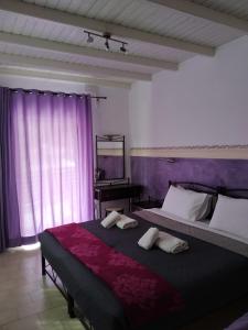 a bedroom with two beds and a mirror and a piano at Manganas Studios in Paleokastritsa