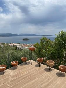 a patio with chairs and a table and a view of the water at Villa Natalia in Tolo