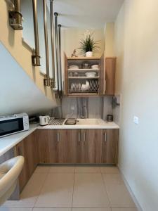 a small kitchen with a sink and a microwave at Villa Natalia in Tolo