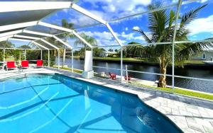 a swimming pool with a view of the water at !NEW! Villa Rosa & Lucia in Cape Coral