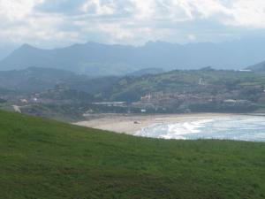 a view of a beach with mountains in the background at Casa La Hayuela Molleda in Ayuela