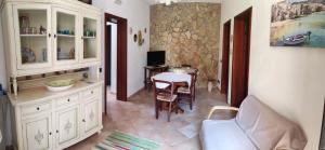 a living room with a couch and a table at L'Azzurro Apartment in Valderice