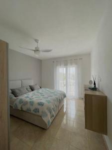 een witte slaapkamer met een bed en een raam bij Appartement MB - Logement 3 chambres - Drage in Drage