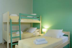 A bed or beds in a room at Ammoudara Bay Villa