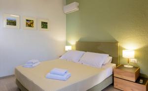 A bed or beds in a room at Ammoudara Bay Villa