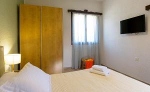 A bed or beds in a room at Ammoudara Bay Villa