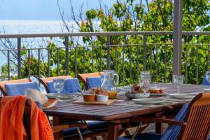 a wooden table with food on it on a balcony at Ammoudara Bay Villa in Agios Nikolaos