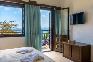A bed or beds in a room at Ammoudara Bay Villa