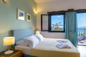 A bed or beds in a room at Ammoudara Bay Villa