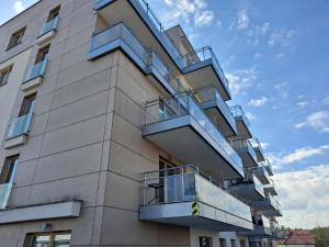 a building with balconies on the side of it at Apartament Wilkasy III (koło Giżycka) in Wilkasy