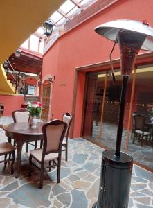 a outdoor patio with a table and a heater at Tabačov Moravia in Brumovice