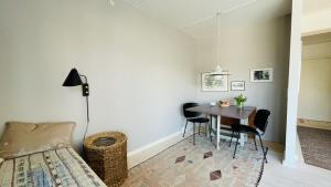 a bedroom with a table and chairs and a bed at ApartmentInCopenhagen Apartment 1487 in Copenhagen