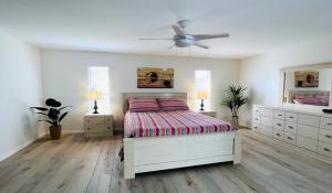 a bedroom with a bed and a ceiling fan at !NEW! Villa Violina in Cape Coral +44 photos