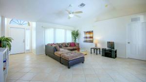 a living room with a couch and a tv at !NEW! Villa Violina in Cape Coral