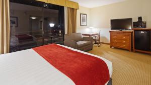 a hotel room with a large bed and a television at Best Western Plus Bayside Inn in San Diego