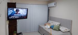 a living room with a flat screen tv on the wall at Sweet Suite Home 1º in Córdoba