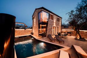 a house with a pool in the middle of a yard at Casa Giulia with heated pool in Privlaka