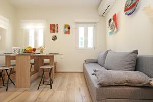 a living room with a couch and a table at CHRISAVGI'S LUXURY HOUSE in Mantoúkion