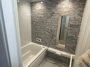a bathroom with a bath tub and a shower at Koya TRIBE - Vacation STAY 48392v in Oishi