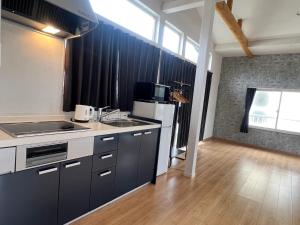 a kitchen with a sink and a refrigerator at Koya TRIBE - Vacation STAY 48392v in Oishi