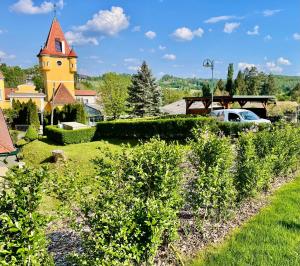 a view of a garden with a church at Chalet mit Pool & Sauna in Ehrenhausen