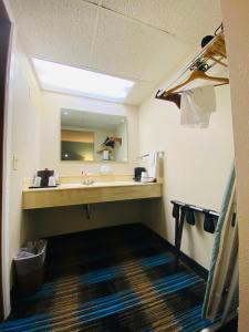 a bathroom with a sink and a large mirror at Days Inn & Suites by Wyndham St. Ignace Lakefront in Saint Ignace +42 photos