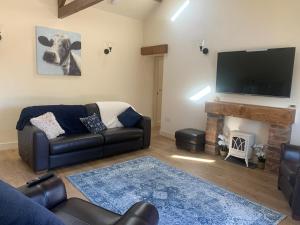 a living room with a couch and a fireplace at Barford barn holiday cottage in Darlington