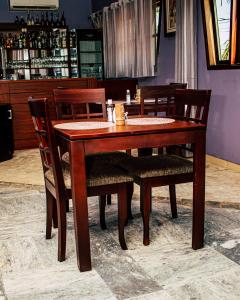 a wooden table and chairs in a restaurant at Résidence Hôtelière Lauria in Lomé