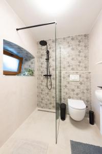 a bathroom with a shower and a toilet at Apartment Olive in Kaštela +65 photos