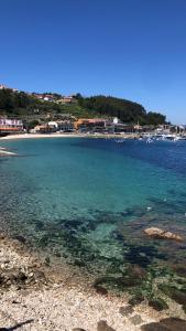 a view of a beach with boats in the water at RIA mar DE BELUSO in Bueu